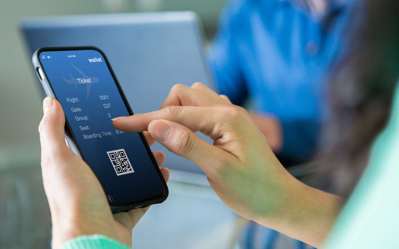 Woman uses smart phone to book travel reservation